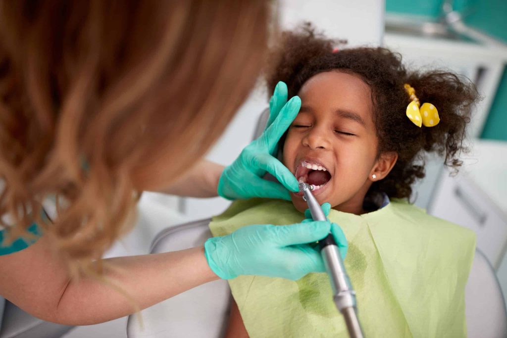 child getting teeth cleaned